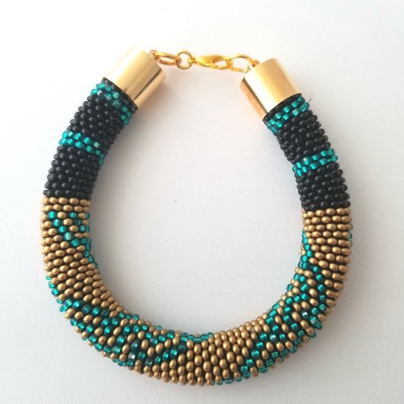 Jewelry - 7" SEED BEAD BRACELET "RAE" WITH A GOLD, BLACK AND BLUE TONE.